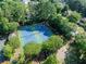 Aerial view of community tennis courts surrounded by lush greenery and trees at 10770 Glenhurst Pass, Duluth, GA 30097