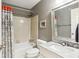Cozy bathroom features a tub with a shower, a toilet, and a vanity with a marble countertop at 1386 Sheffield Glen Ne Way, Atlanta, GA 30329