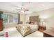 Comfortable bedroom featuring a ceiling fan, large window, and neutral color palette at 1386 Sheffield Glen Ne Way, Atlanta, GA 30329