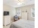 Bright bedroom showcases a wicker chair, window, dresser, and bed with a patterned gray cover at 1386 Sheffield Glen Ne Way, Atlanta, GA 30329