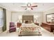 Cozy bedroom with a tufted headboard, side tables, and a large window with natural light at 1386 Sheffield Glen Ne Way, Atlanta, GA 30329