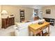Neutral living room features a sofa, dresser, table with shelves and carpet at 1386 Sheffield Glen Ne Way, Atlanta, GA 30329