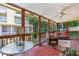 Enclosed porch featuring a ceiling fan, neighborhood views, and comfortable seating at 1386 Sheffield Glen Ne Way, Atlanta, GA 30329