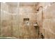 Close up of a modern tiled shower with a rainfall shower head and built-in soap dish at 1386 Sheffield Glen Ne Way, Atlanta, GA 30329