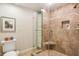 Modern shower with tiled walls, a glass door, and built-in shelving for storage at 1386 Sheffield Glen Ne Way, Atlanta, GA 30329