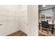 Pantry with wire shelving and a view into the breakfast nook with wooden floors, dark ceiling, and modern decor at 1909 Van Allen Ct, Dacula, GA 30019