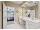 Bathroom view features double sinks, large mirror, and natural light at 25 Hampreston Court Ct, Johns Creek, GA 30022