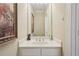 Clean bathroom features a vanity with sink, decorative mirror, and storage at 25 Hampreston Court Ct, Johns Creek, GA 30022