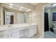 Bathroom with double sinks, white cabinets, and ample counter space at 25 Hampreston Court Ct, Johns Creek, GA 30022