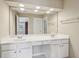 Bright bathroom with double sinks, white cabinets, and a large mirror at 25 Hampreston Court Ct, Johns Creek, GA 30022