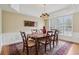 Elegant dining room with a chandelier, hardwood floors, and a large window at 25 Hampreston Court Ct, Johns Creek, GA 30022