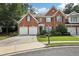 Charming brick home featuring a well-manicured lawn, two-car garage, and inviting curb appeal at 25 Hampreston Court Ct, Johns Creek, GA 30022