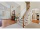 Bright foyer with hardwood floors and a staircase leading to the upper level at 25 Hampreston Court Ct, Johns Creek, GA 30022
