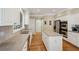 Bright kitchen with stainless steel appliances, white cabinets, light countertop, and a view into the hall at 25 Hampreston Court Ct, Johns Creek, GA 30022