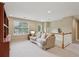 Upstairs living room includes a comfortable couch and built in bookshelves at 25 Hampreston Court Ct, Johns Creek, GA 30022