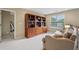 Upstairs living room includes built in bookshelves and a comfortable seating area at 25 Hampreston Court Ct, Johns Creek, GA 30022