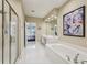 Main bathroom features a glass shower and bathtub with a double sink vanity and a large mirror at 25 Hampreston Court Ct, Johns Creek, GA 30022