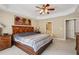 Primary bedroom with tray ceilings, ceiling fan, and furniture set at 25 Hampreston Court Ct, Johns Creek, GA 30022