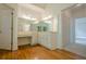Bathroom vanity with large mirror and ample storage space, set against warm hardwood flooring at 2814 Tanner Lake Nw Trl, Marietta, GA 30064