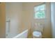 Bathroom featuring a standard white toilet, bathtub, and window at 2814 Tanner Lake Nw Trl, Marietta, GA 30064