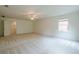 A spacious bedroom boasts two windows, carpet flooring, and a ceiling fan at 2814 Tanner Lake Nw Trl, Marietta, GA 30064
