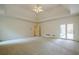 Expansive bedroom with tray ceiling, plush carpet, and access to a private outdoor space at 2814 Tanner Lake Nw Trl, Marietta, GA 30064