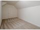 Carpeted bedroom with neutral walls with sloped ceilings and a closet at 2814 Tanner Lake Nw Trl, Marietta, GA 30064