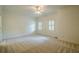 A bedroom with a ceiling fan and two windows at 2814 Tanner Lake Nw Trl, Marietta, GA 30064