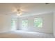 A spacious bedroom boasts three windows, carpet flooring, and a ceiling fan at 2814 Tanner Lake Nw Trl, Marietta, GA 30064