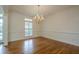 This dining room features hardwood floors, white trim, and a charming chandelier at 2814 Tanner Lake Nw Trl, Marietta, GA 30064