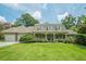Traditional home featuring a manicured lawn, covered porch, dormer windows, and a side-entry garage at 2814 Tanner Lake Nw Trl, Marietta, GA 30064