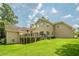 Home exterior featuring a large yard, deck, and lush green landscaping at 2814 Tanner Lake Nw Trl, Marietta, GA 30064