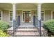 Elegant front entrance with a wooden door, stone steps, and black iron railings at 2814 Tanner Lake Nw Trl, Marietta, GA 30064