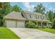 Traditional home showcasing an attached two-car garage and manicured lawn at 2814 Tanner Lake Nw Trl, Marietta, GA 30064