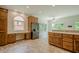 This kitchen features wood cabinetry, desk-like countertop, and black appliances at 2814 Tanner Lake Nw Trl, Marietta, GA 30064