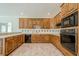 The kitchen features wood cabinets, backsplash, a black dishwasher, microwave and oven at 2814 Tanner Lake Nw Trl, Marietta, GA 30064