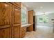 Open kitchen with wood cabinetry and desk-like countertop with backyard views at 2814 Tanner Lake Nw Trl, Marietta, GA 30064