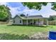 The backyard boasts a covered patio and plenty of green space, making it ideal for outdoor living and entertaining at 3573 Plantation Pl, Loganville, GA 30052
