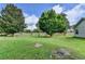 The backyard features a wooden fence, mature trees, and green space, providing privacy and room for outdoor activities at 3573 Plantation Pl, Loganville, GA 30052