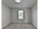 Bedroom features large arched window with blinds and neutral carpeting at 3573 Plantation Pl, Loganville, GA 30052