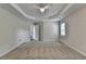 Large bedroom with a ceiling fan, neutral walls, and an open doorway at 3573 Plantation Pl, Loganville, GA 30052