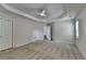 Primary bedroom with a ceiling fan, double doors, and neutral paint at 3573 Plantation Pl, Loganville, GA 30052