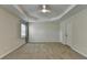 Spacious bedroom featuring a tray ceiling, ceiling fan, and neutral-toned walls at 3573 Plantation Pl, Loganville, GA 30052