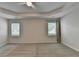 Bright bedroom with natural light from two windows, a ceiling fan, and plush carpeting at 3573 Plantation Pl, Loganville, GA 30052