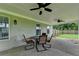 Covered patio features ceiling fans and outdoor seating, perfect for entertaining or relaxing outdoors at 3573 Plantation Pl, Loganville, GA 30052