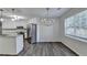 Open-concept dining area with wood-look flooring and a contemporary chandelier at 3573 Plantation Pl, Loganville, GA 30052