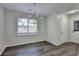 Charming dining area with new flooring and a modern chandelier at 3573 Plantation Pl, Loganville, GA 30052