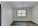 Dining area with new floors and a modern chandelier at 3573 Plantation Pl, Loganville, GA 30052