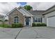 Close up of front facade showing stone veneer, blue front door, and garage at 3573 Plantation Pl, Loganville, GA 30052