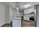 Remodeled kitchen with stainless appliances, granite counters, and modern lighting at 3573 Plantation Pl, Loganville, GA 30052